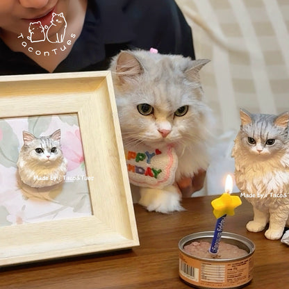 Persian cat celebrating birthday next to its custom hand-painted figurine and framed version by TaconTues