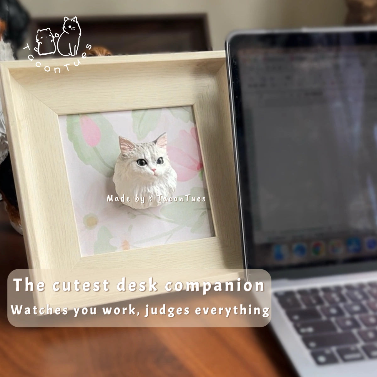 Custom hand-painted cat figurine displayed in a wooden frame on an office desk next to a laptop