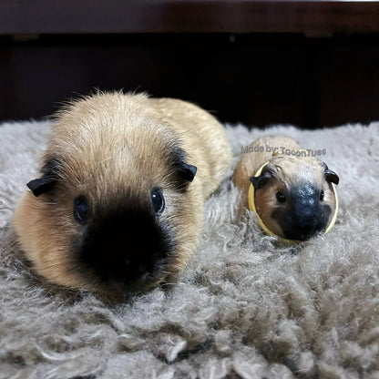 Adorable guinea pig sculpture by TaconTues, placed beside real guinea pig on fluffy rug — detailed handmade tribute for small pet enthusiasts
